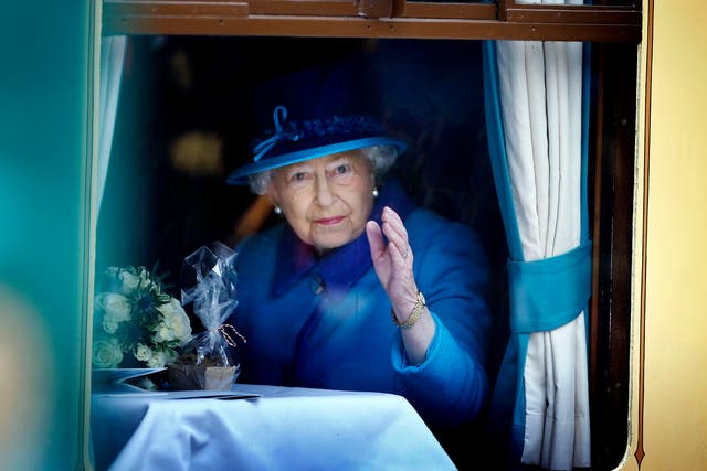 The Queen, on the day she became Britain’s longest reigning monarch, waves from a carriage window at Edinburgh’s Waverley Station (Danny Lawson/PA)