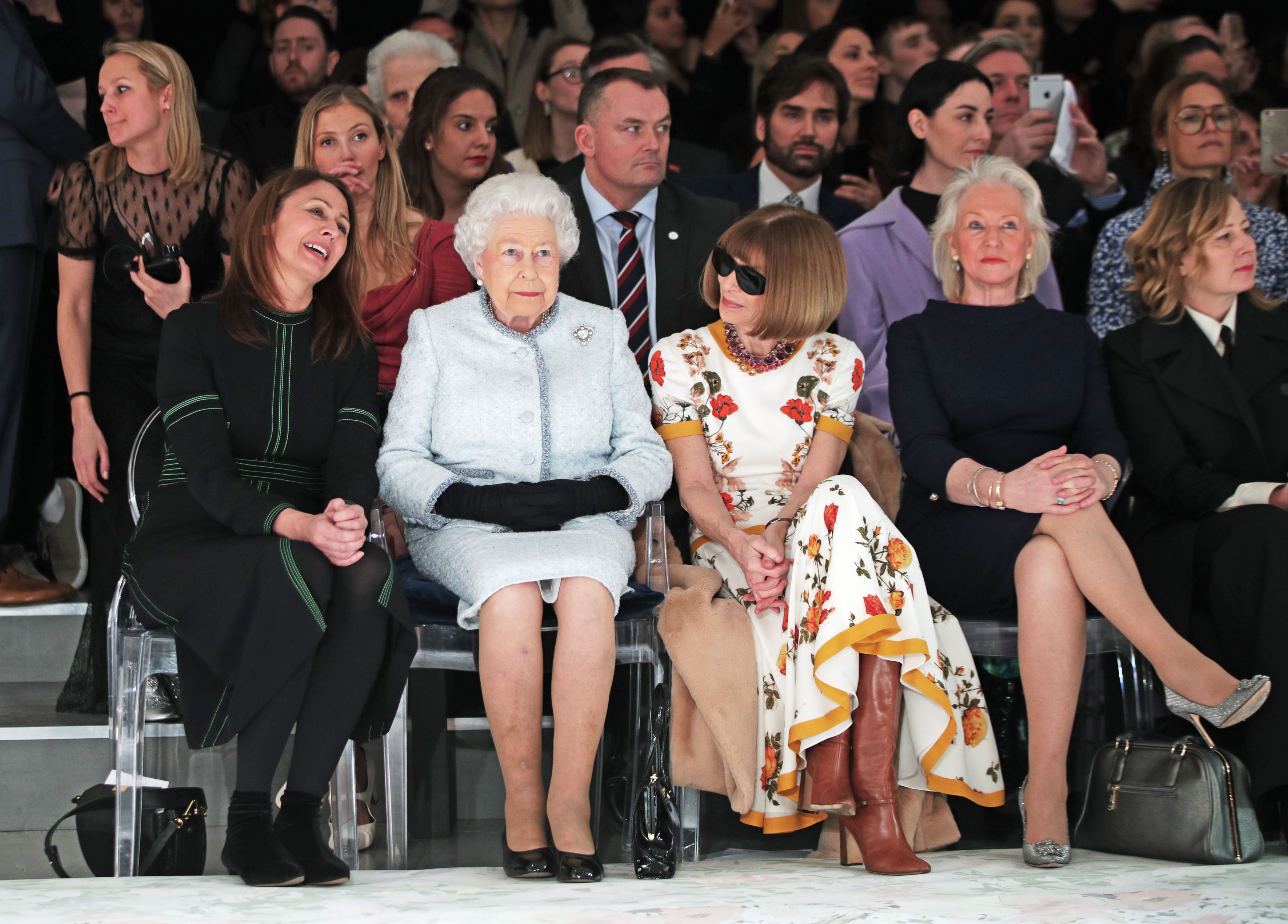 The Queen with Anna Wintour to her left and royal dressmaker Angela Kelly, second right, at London Fashion Week