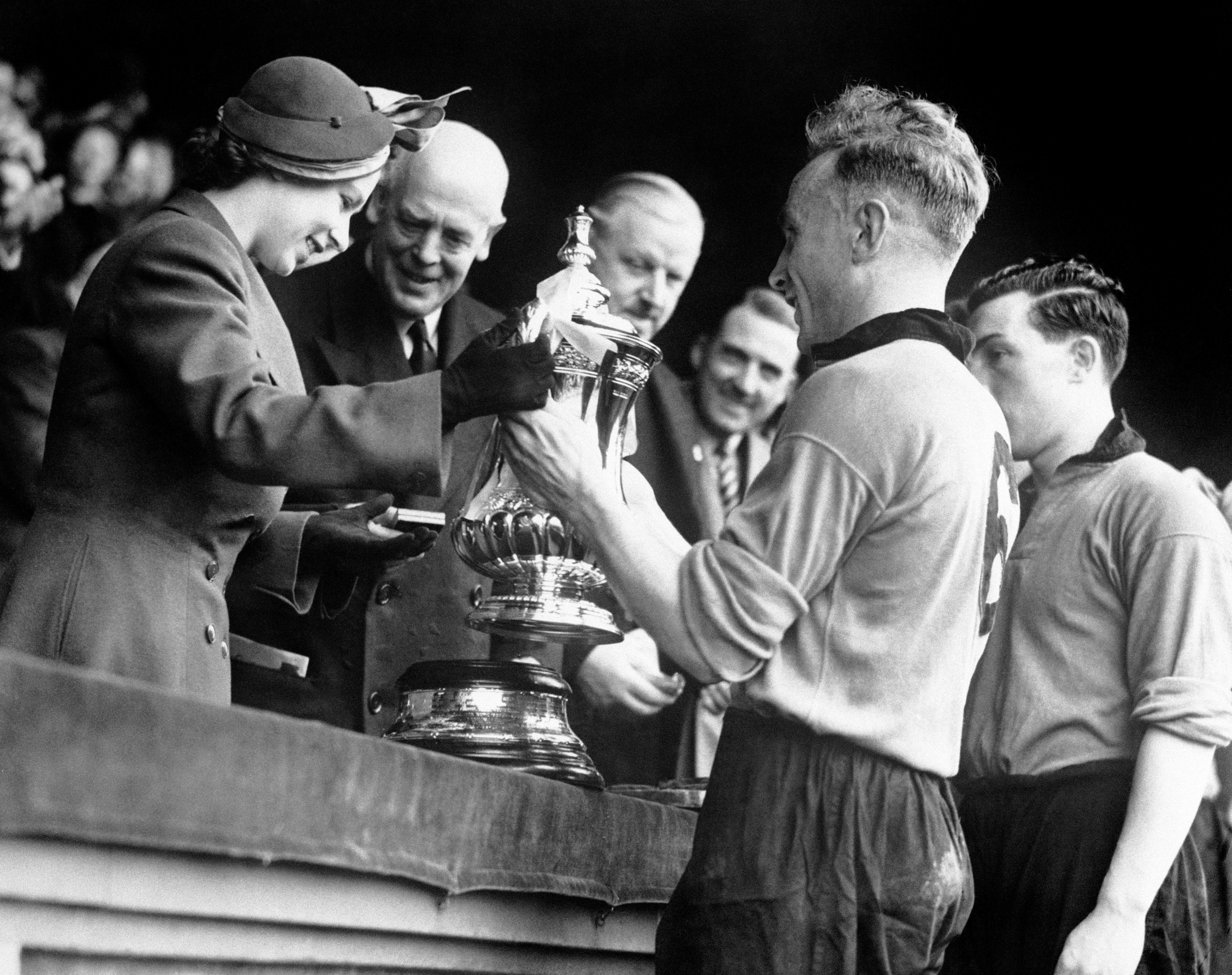 In 1949, before becoming Queen, then Princess Elizabeth presented the FA Cup to Wolves captain Billy Wright (PA Archive)