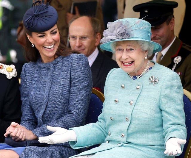 The Duchess of Cambridge laughs as the Queen gestures while they watch part of a children’s sports event during a visit to Vernon Park in Nottingham (Phil Noble/PA)