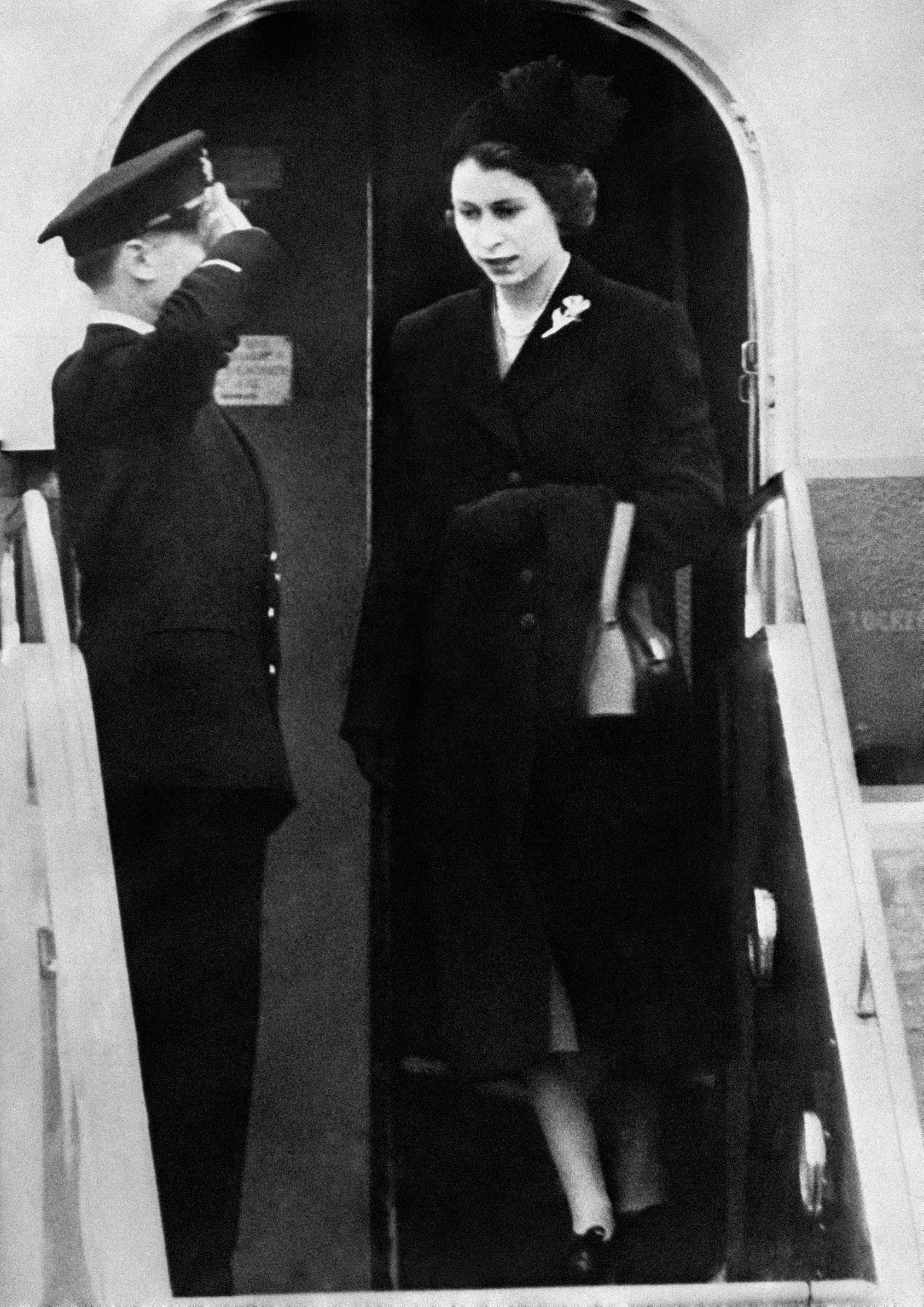 Dressed in black, Queen Elizabeth II sets foot on British soil for the first time since her accession as she lands at London Airport following the death of her father King George VI (PA)