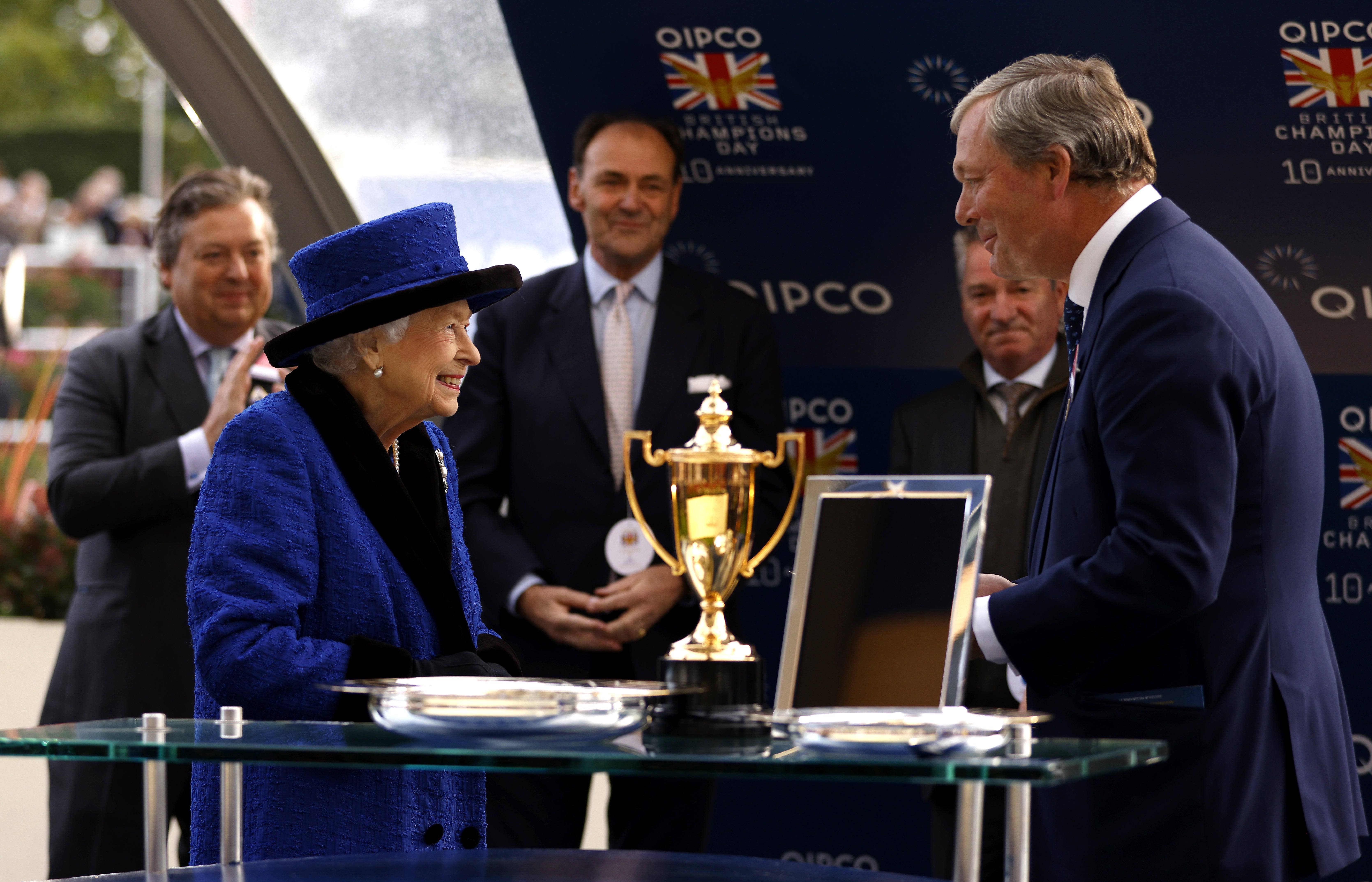 Queen Elizabeth II presentis the trophy to trainer William Haggas after the Queen Elizabeth II Stakes at Ascot in 2021 (PA)