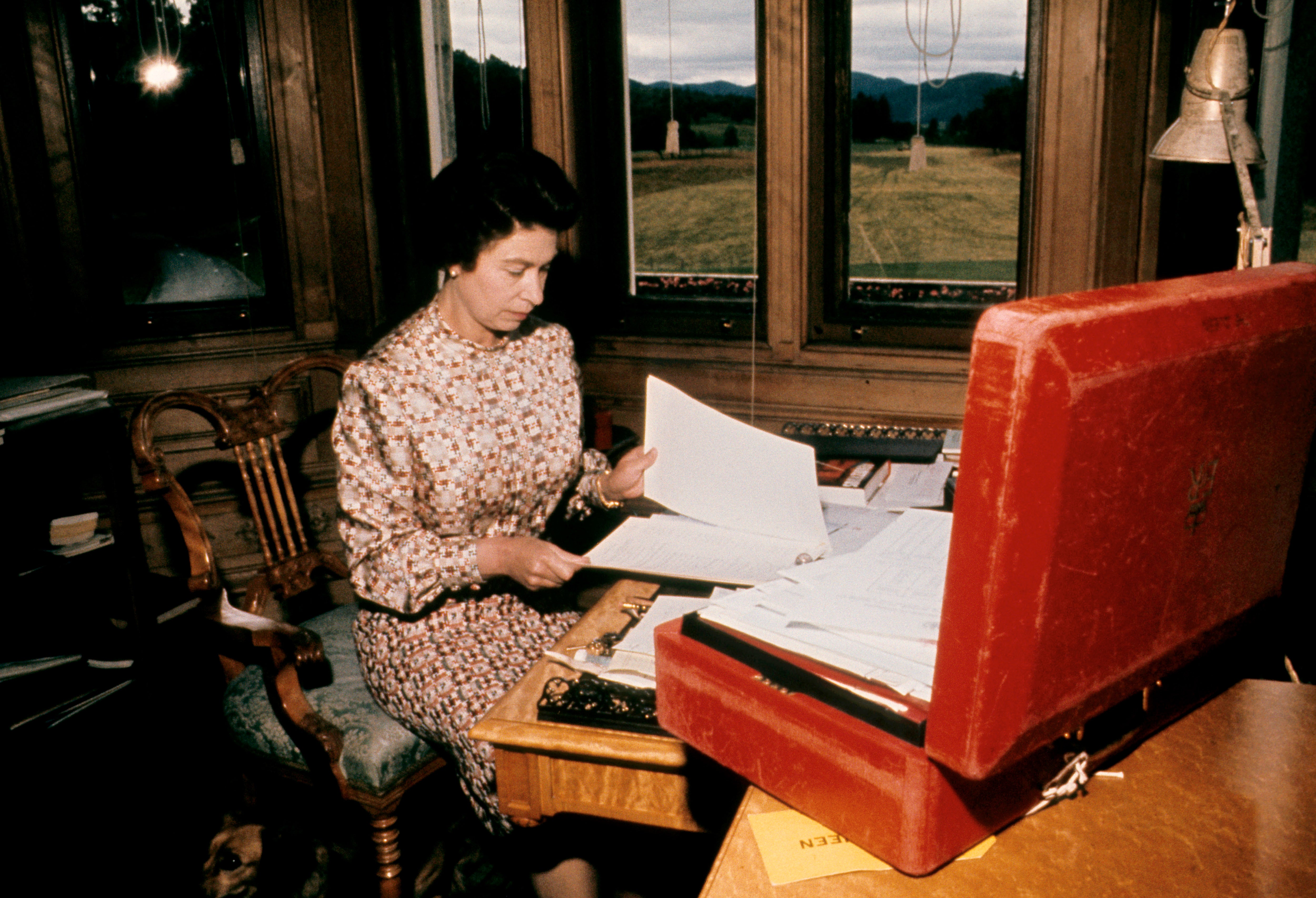 The Queen working through her red box of official papers at Balmoral (PA)