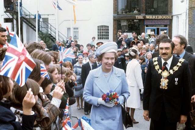 The Queen meets an enthusiastic crowd at St Katherine’s Dock near the Tower of London, one of the stops on her Silver Jubilee river progress (PA)