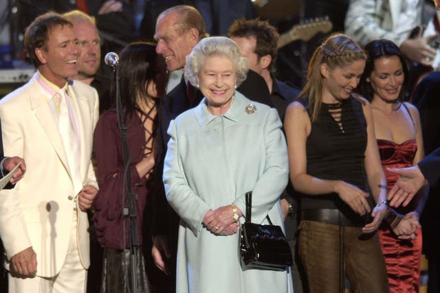 The Queen meets artists on stage in the gardens of Buckingham Palace, after the second concert to commemorate the Golden Jubilee (Stefan Rousseau/PA)