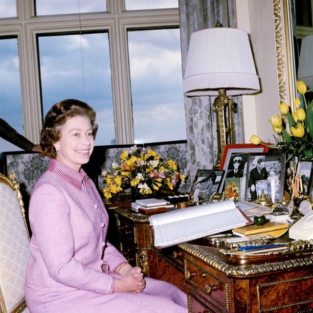 The Queen at her desk at Windsor castle in 1977 (PA)