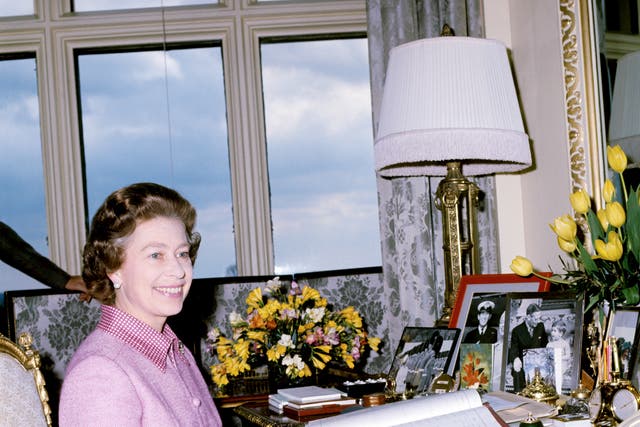 The Queen at her desk at Windsor castle in 1977 (PA)
