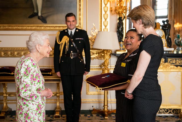 The Queen presenting the George Cross to Amanda Pritchard, chief executive of NHS England, right, and May Parsons, Modern Matron at University Hospital Coventry and Warkwickshire, representatives of the National Health Service (Aaron Chown/PA)