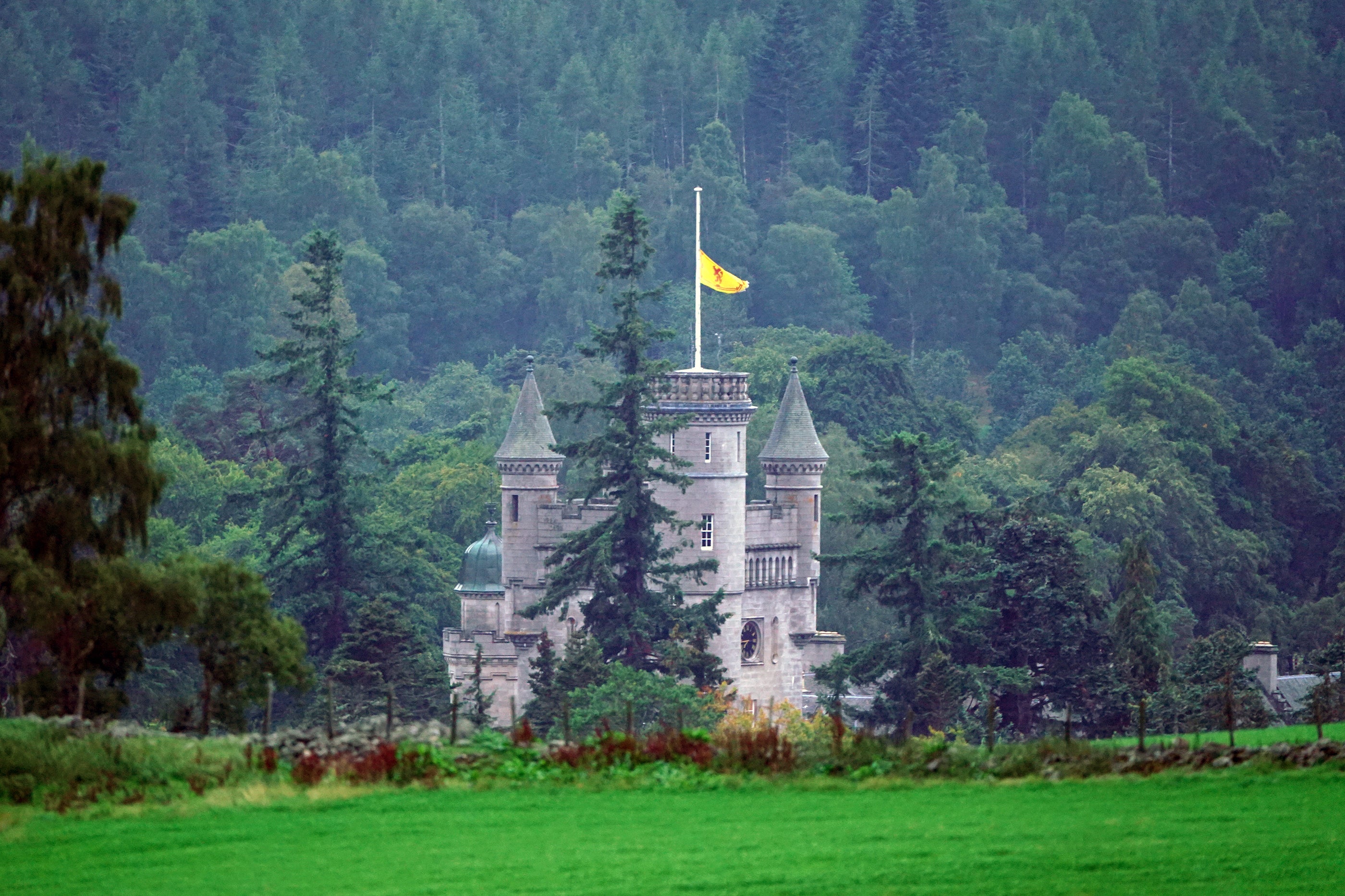The Royal Banner of Scotland above Balmoral Castle is flown at half mast following the announcement (Owen Humphreys/PA)