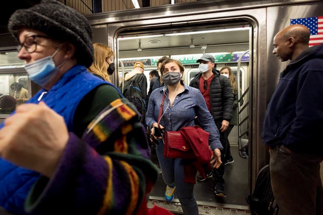 <p>People enter and exit a New York City subway car in New York, New York, USA, 21 April 2022</p>