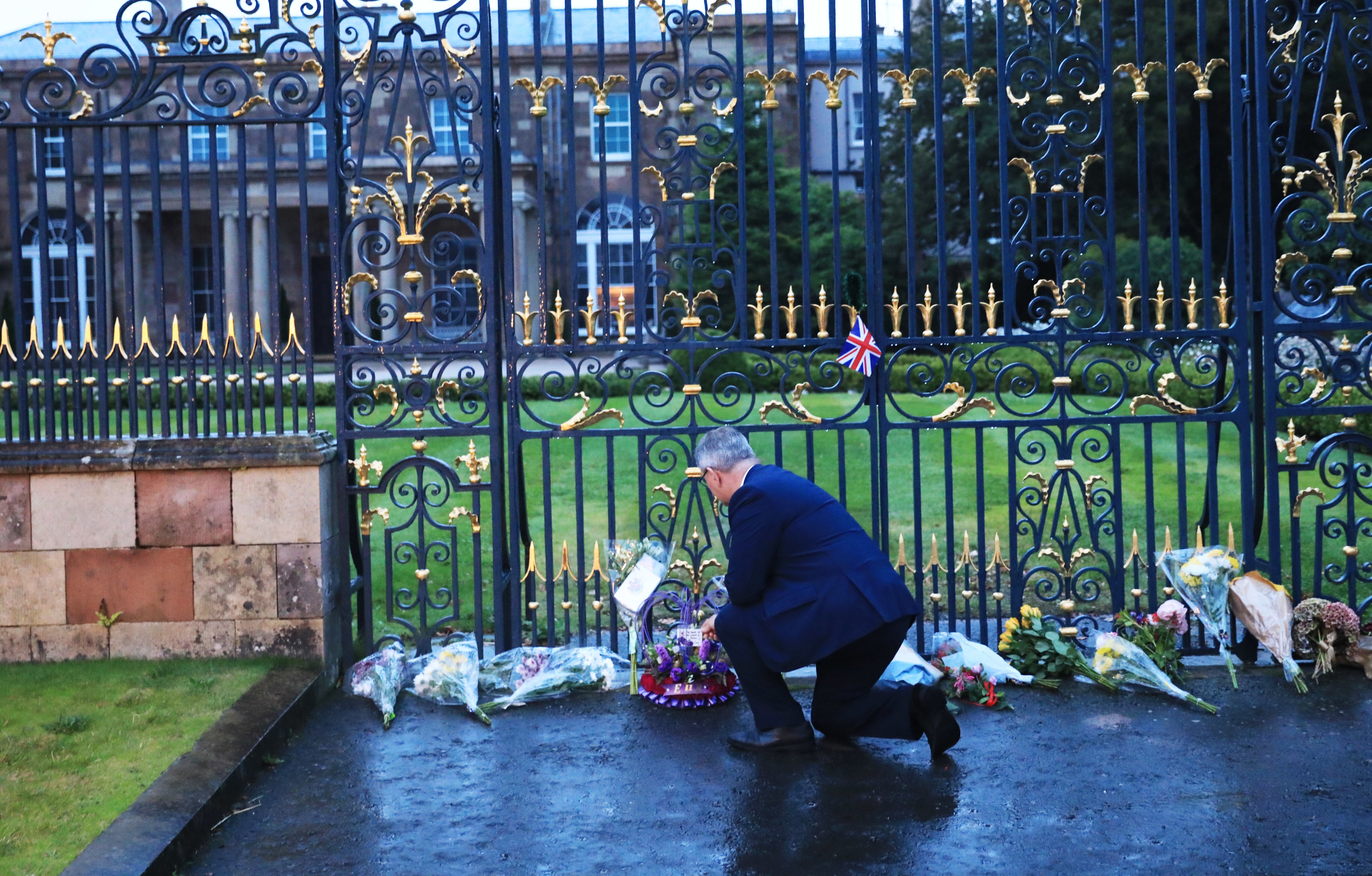 DUP leader Jeffrey Donaldson looks at floral tributes at Hillsborough Castle (Peter Morrison/PA)
