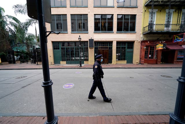 <p>A police officer walks down a nearly deserted Bourbon Street during Mardi Gras in the French Quarter of New Orleans</p>