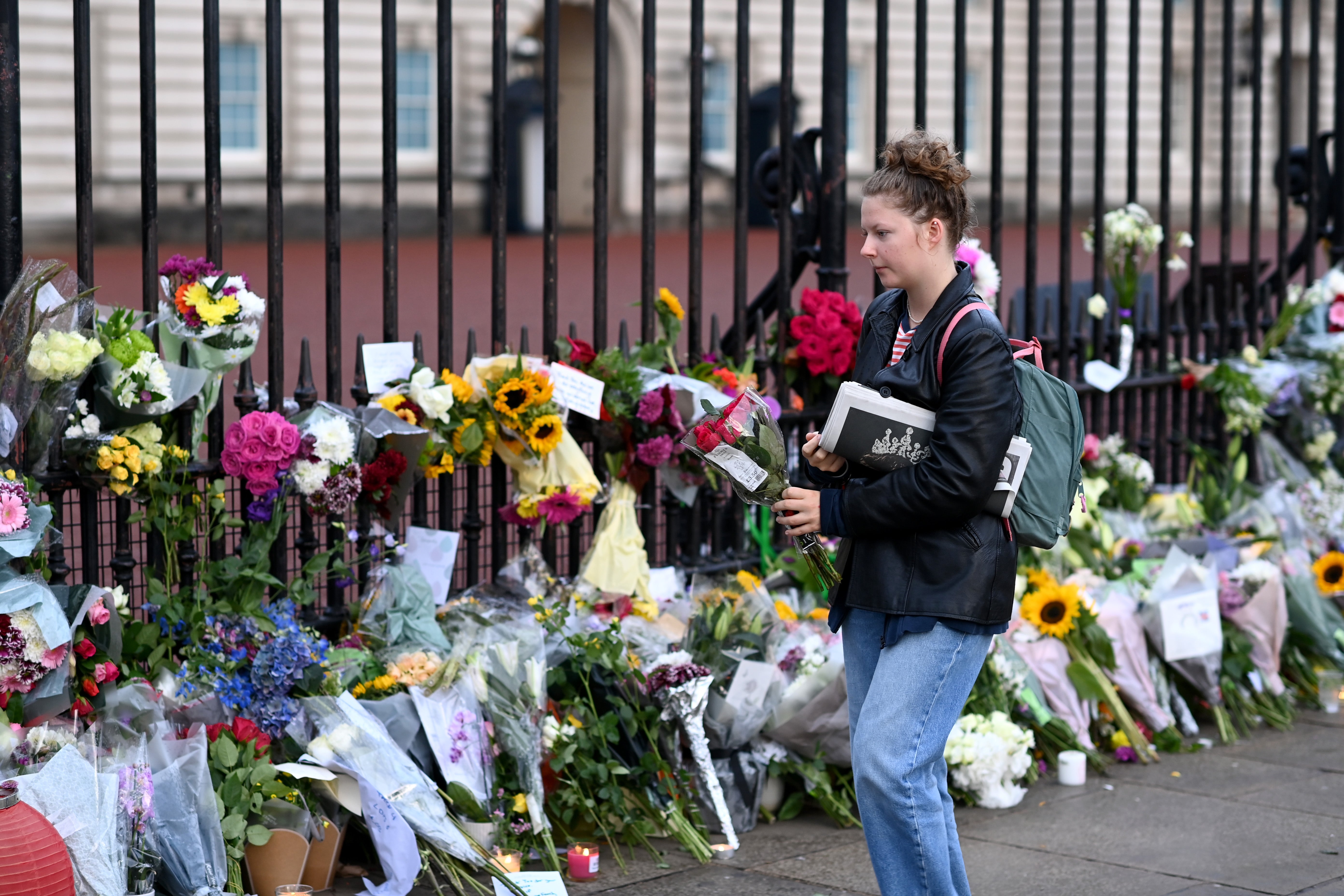 Flowers are laid outside Buckingham Palace following the death of Queen Elizabeth II.
