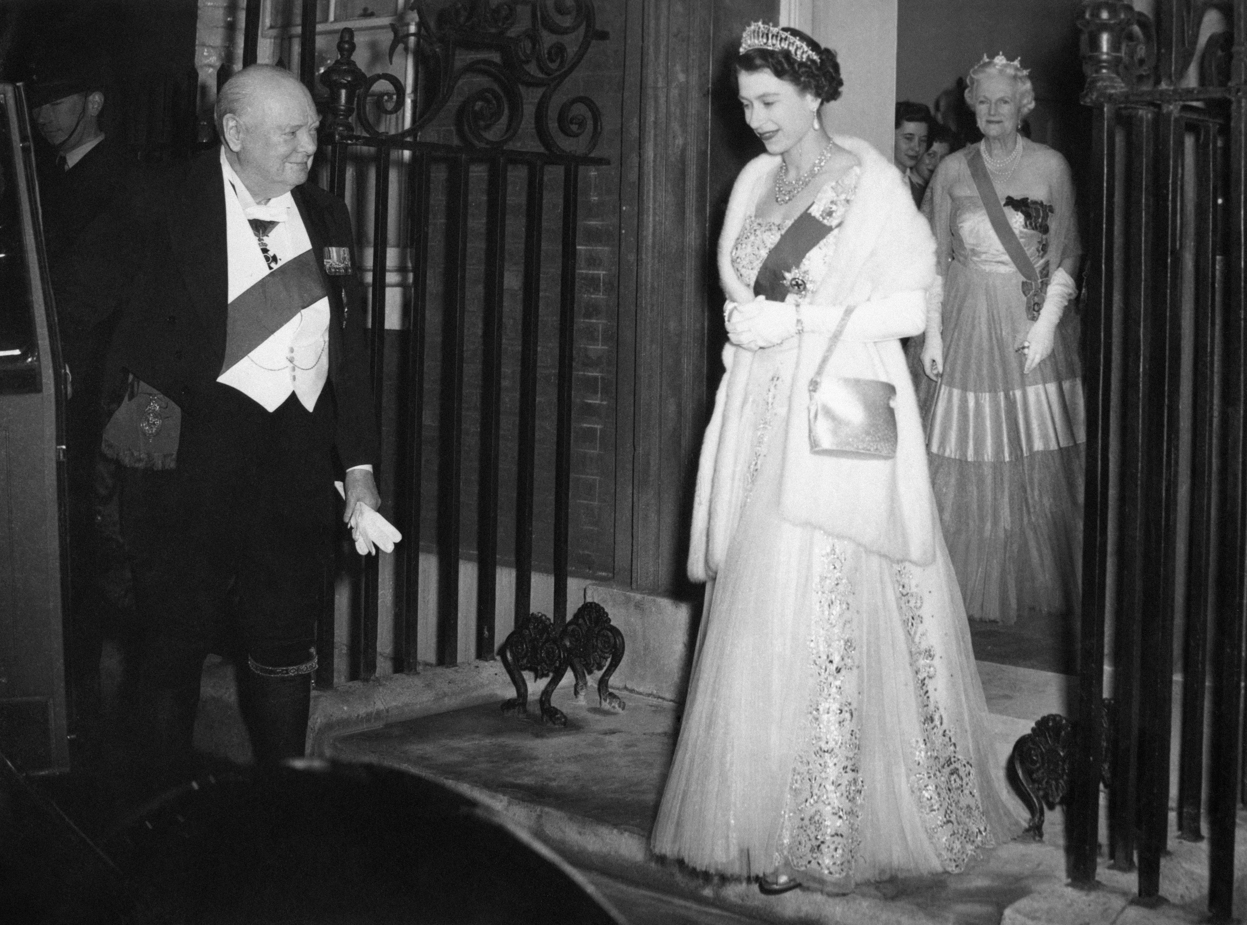 Sir Winston Churchill opening the door of Queen Elizabeth’s car, as she and the Duke of Edinburgh leave after dining with him and other guests in April 1955 (PA Wire/PA Images)