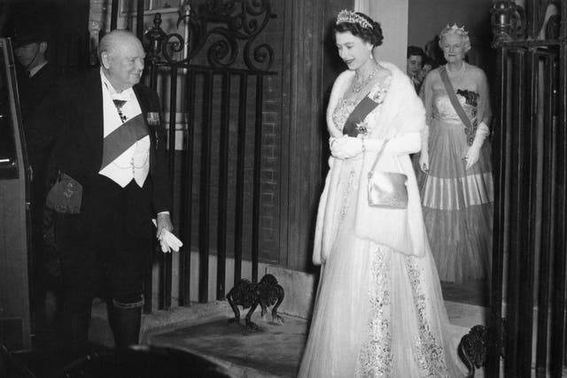 Sir Winston Churchill opening the door of Queen Elizabeth’s car, as she and the Duke of Edinburgh leave after dining with him and other guests in April 1955 (PA Wire/PA Images)
