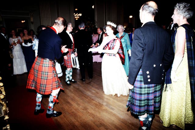 Queen Elizabeth II, takes to the floor with the Duke of Edinburgh during the Centenary Ball of the Scottish Pipers’ Society at the Assembly Room, Edinburgh (PA)
