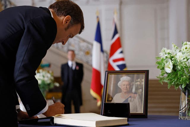 <p>French President Emmanuel Macron signs a condolence book, next to a portrait of Queen Elizabeth II, at the British Embassy in Paris </p>