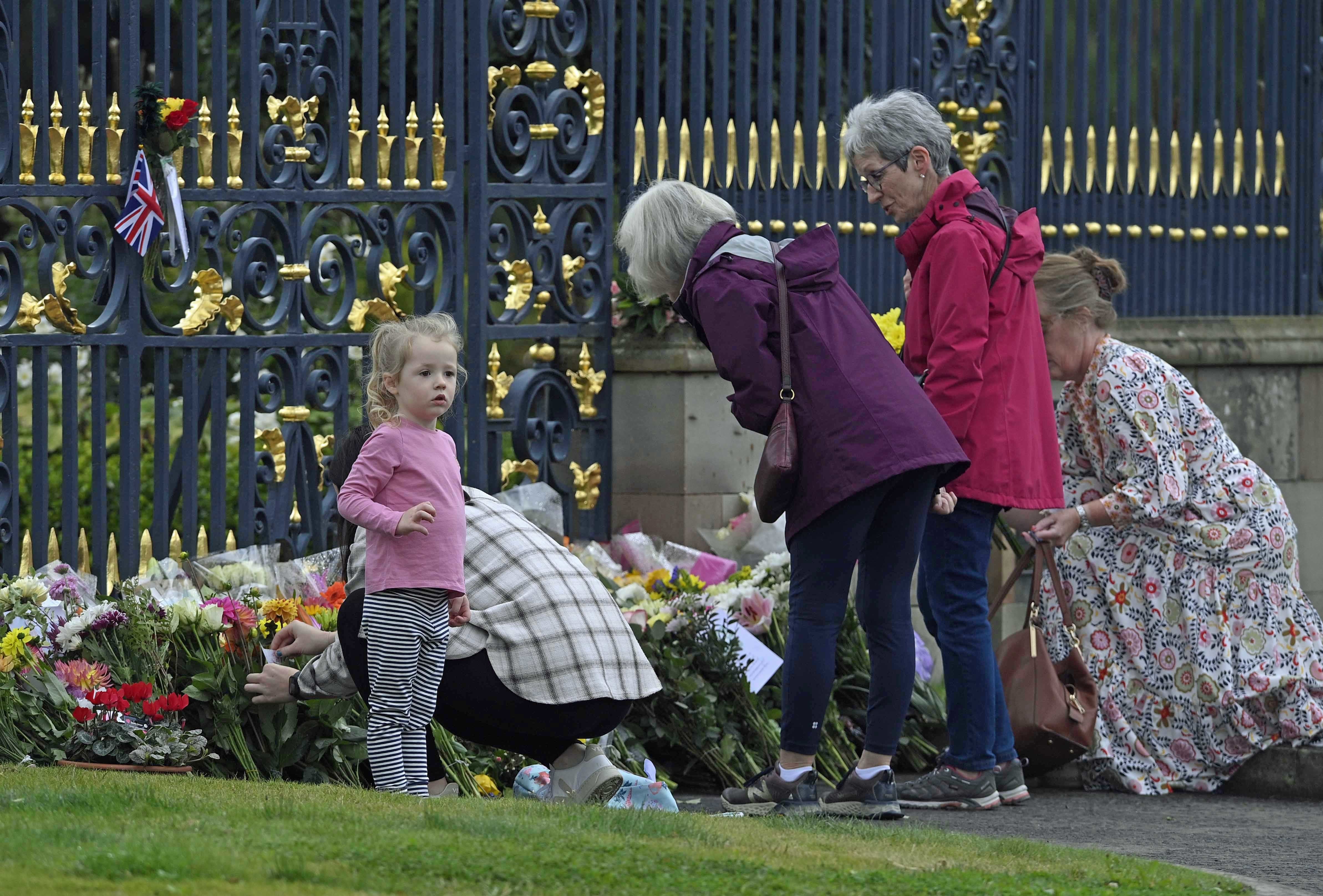 Mourners at the gates of Hillsborough Castle in Co Down (Mark Marlow/PA)