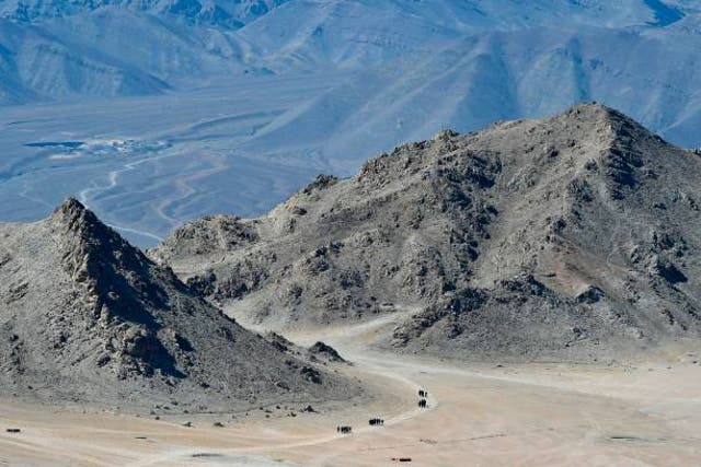<p>Indian soldiers walk at the foothills of a mountain range near Leh on June 23, 2020</p>
