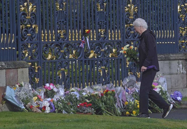 Lady Mary Elizabeth Peters lays flowers at the gates of Hillsborough Castle in Co Down, as she pays her respects (Mark Marlow/PA)