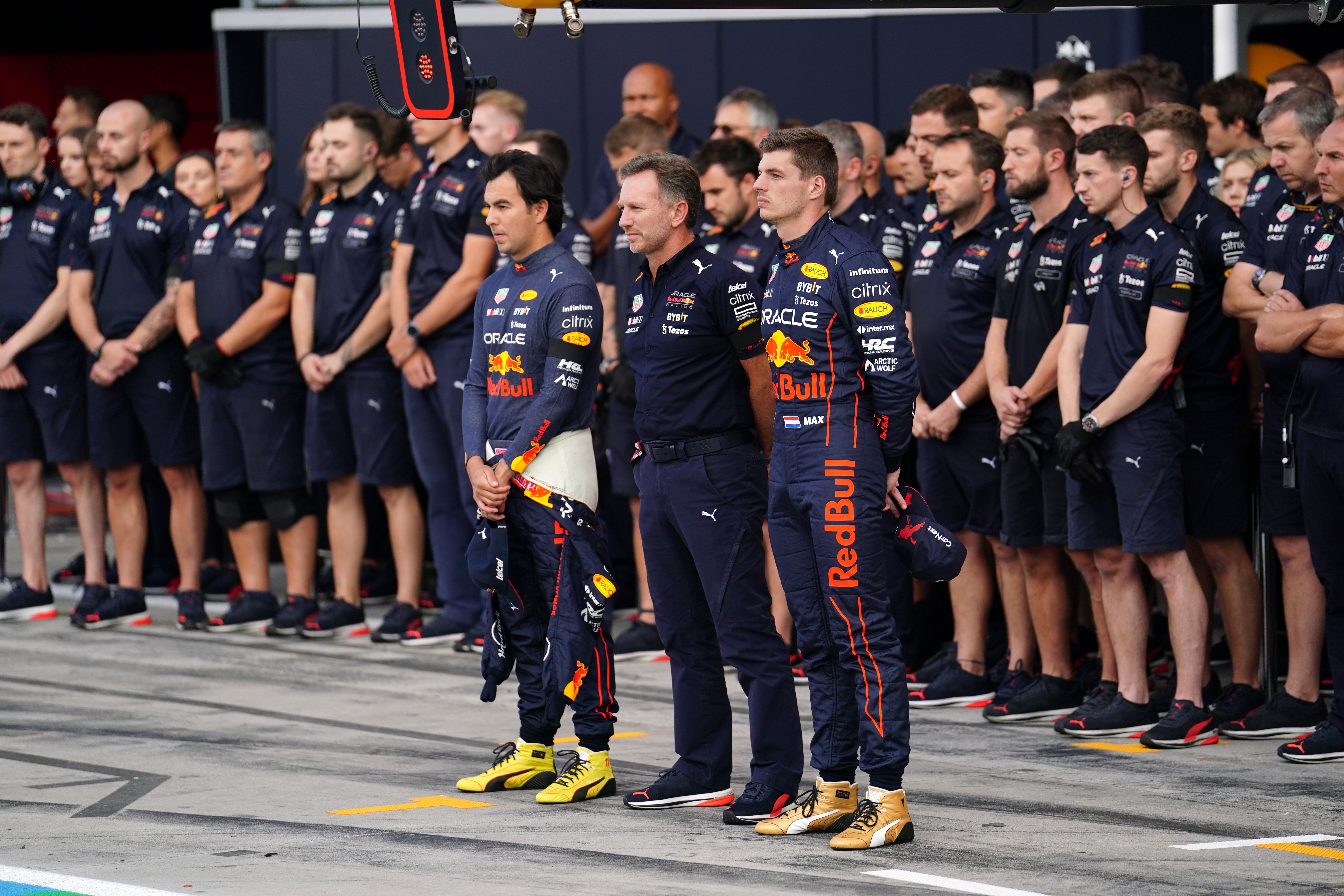 World champion Max Verstappen observes the one-minute silence alongside Red Bull team principal Christian Horner and team-mate Sergio Perez (David Davies/PA)
