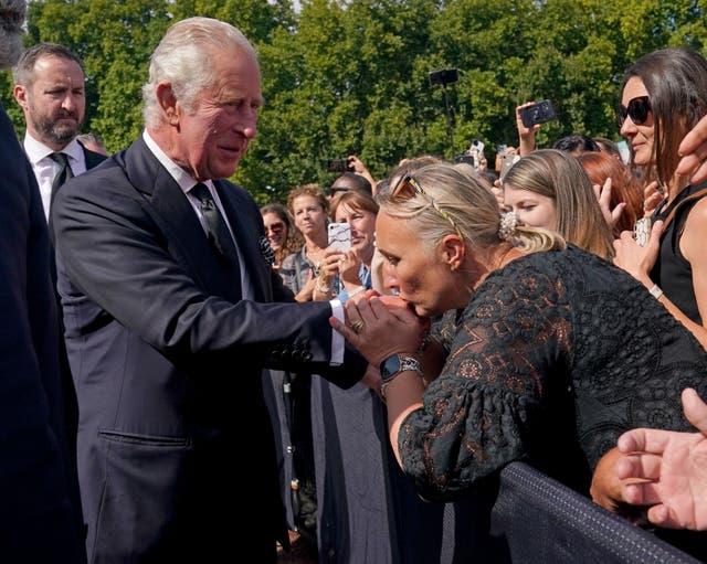 A well-wisher kisses the hand of King Charles III (Yui Mok/PA)