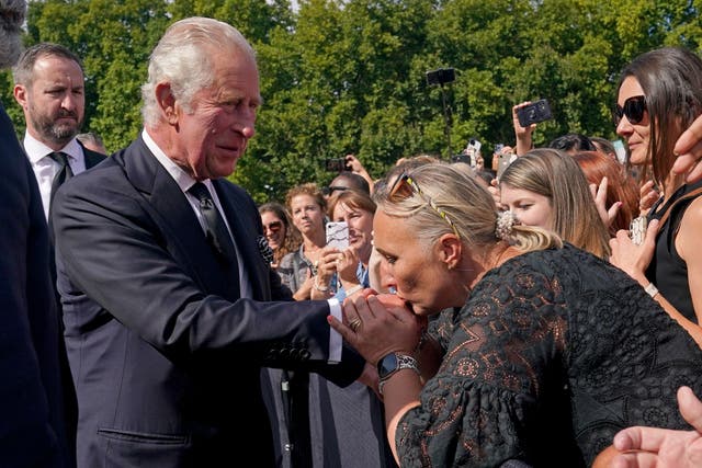 A well-wisher kisses the hand of King Charles III (Yui Mok/PA)