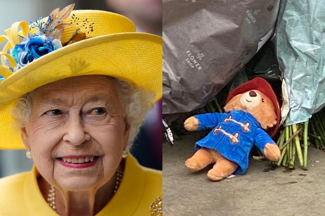 <p>The Queen, and a Paddington Bear figure left outside Buckingham Palace</p>