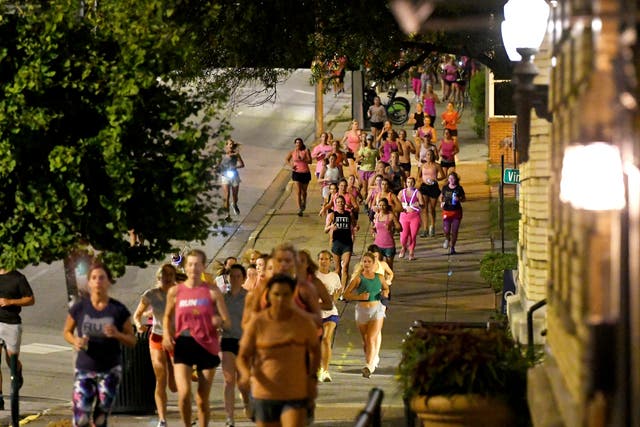 <p>Runners head down the sidewalk past Fountain Square during ‘Finish Eliza’s Run’ on Friday morning in Chattanooga, Tennessee </p>
