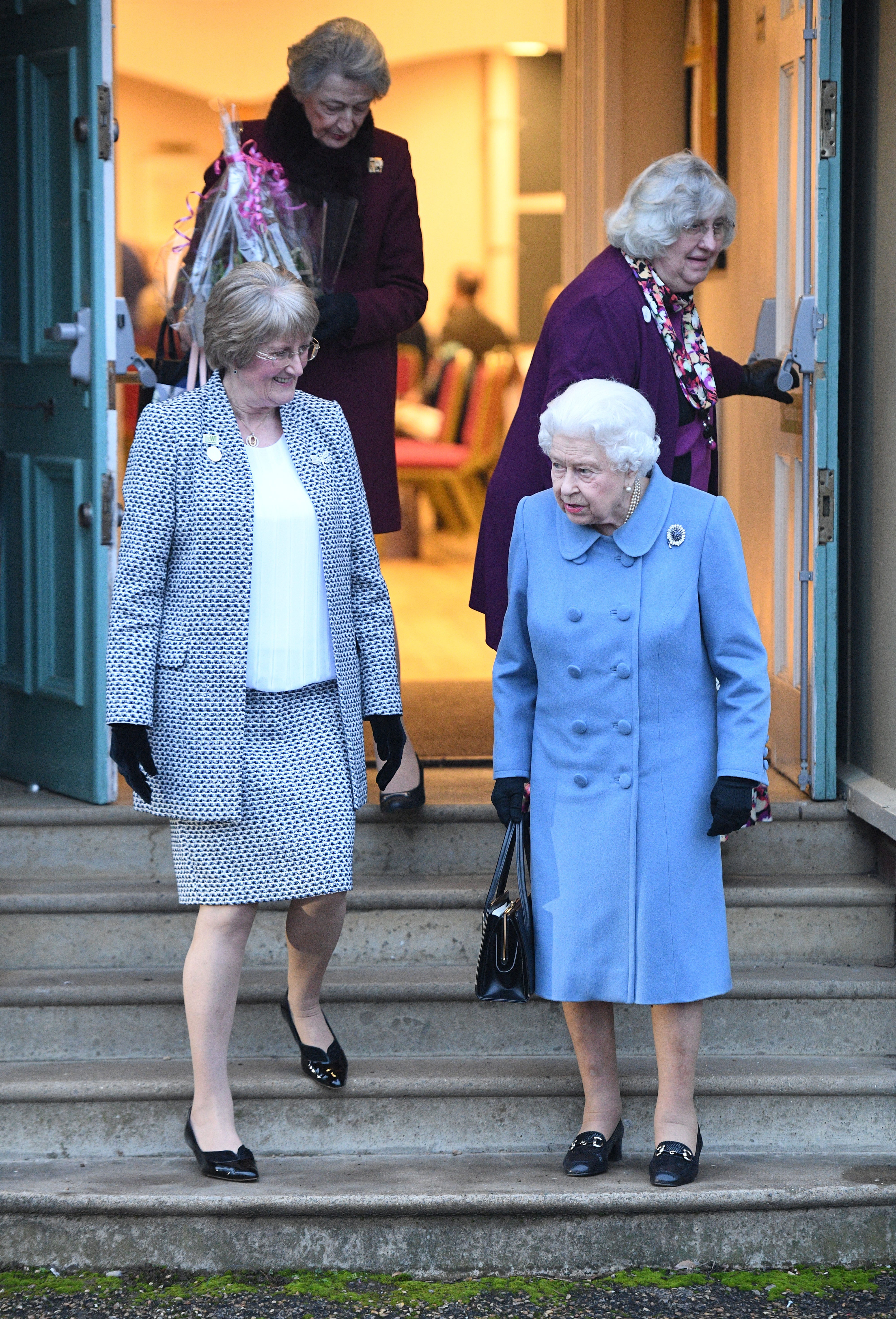 The Queen leaves after attending a Sandringham Women’s Institute meeting at West Newton Village Hall, Norfolk, with chairman Yvonne Browne (Joe Giddens/PA)