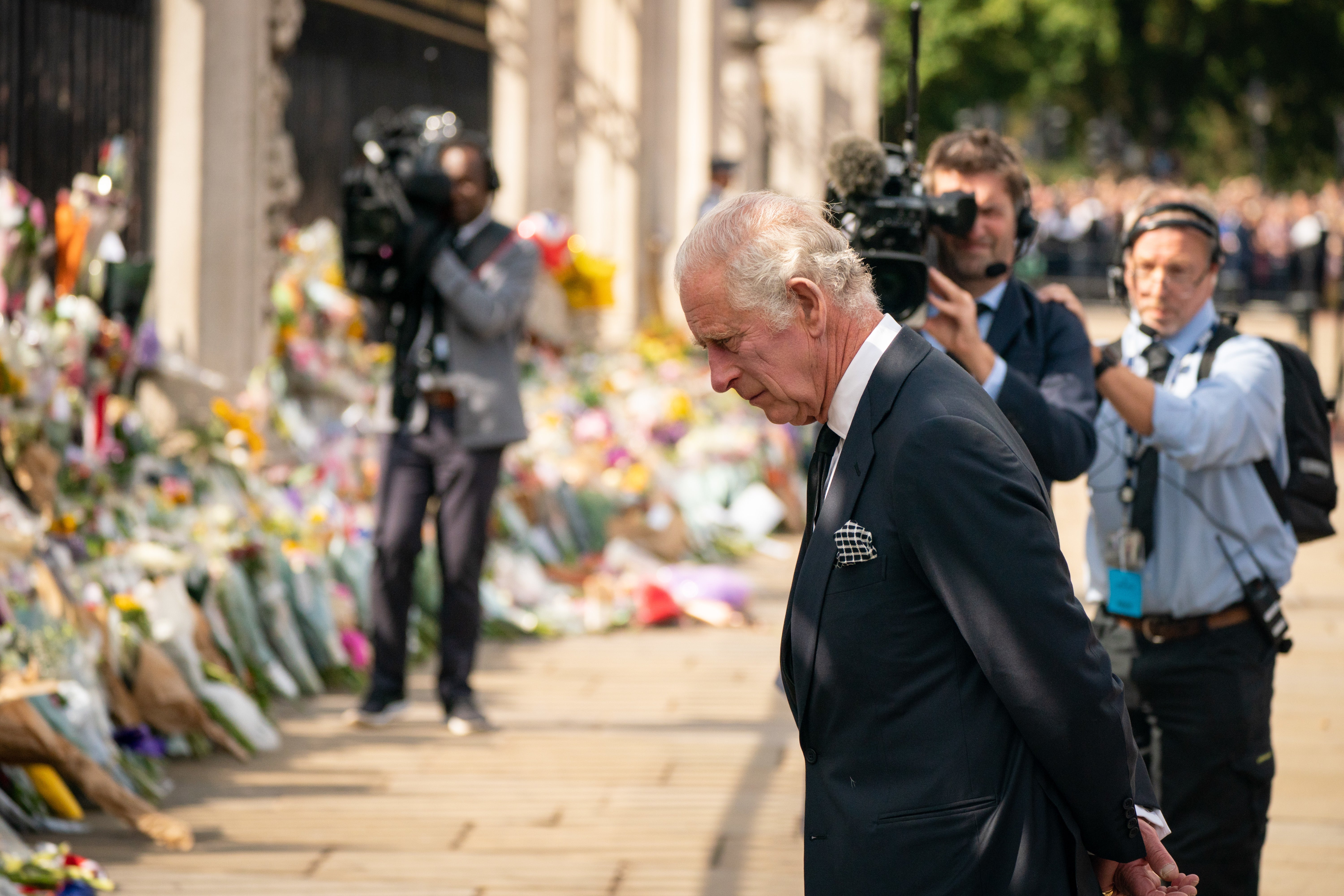 The King viewed floral tributes outside Buckingham Palace on Friday