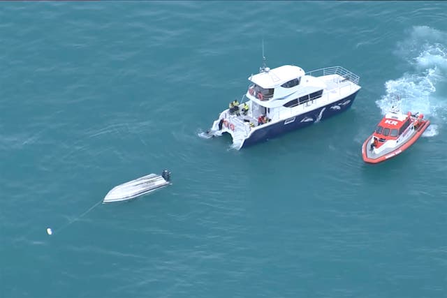 <p>An aerial view shows two rescue boats alongside a capsized boat Saturday, 10 September 2022, Kaikoura, New Zealand</p>