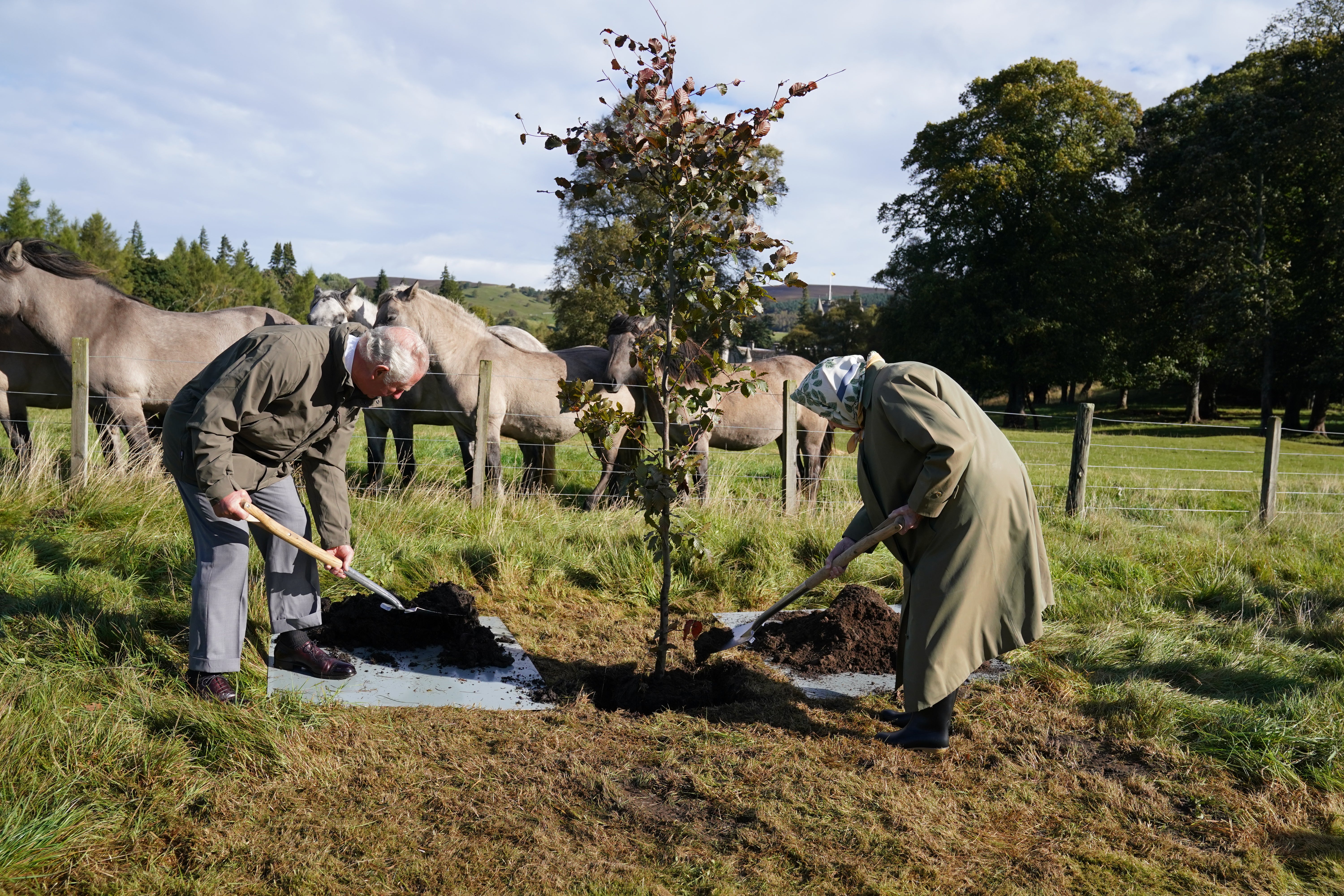 Queen Elizabeth II and the then Prince of Wales plant a tree at the Balmoral Cricket Pavilion in 2021