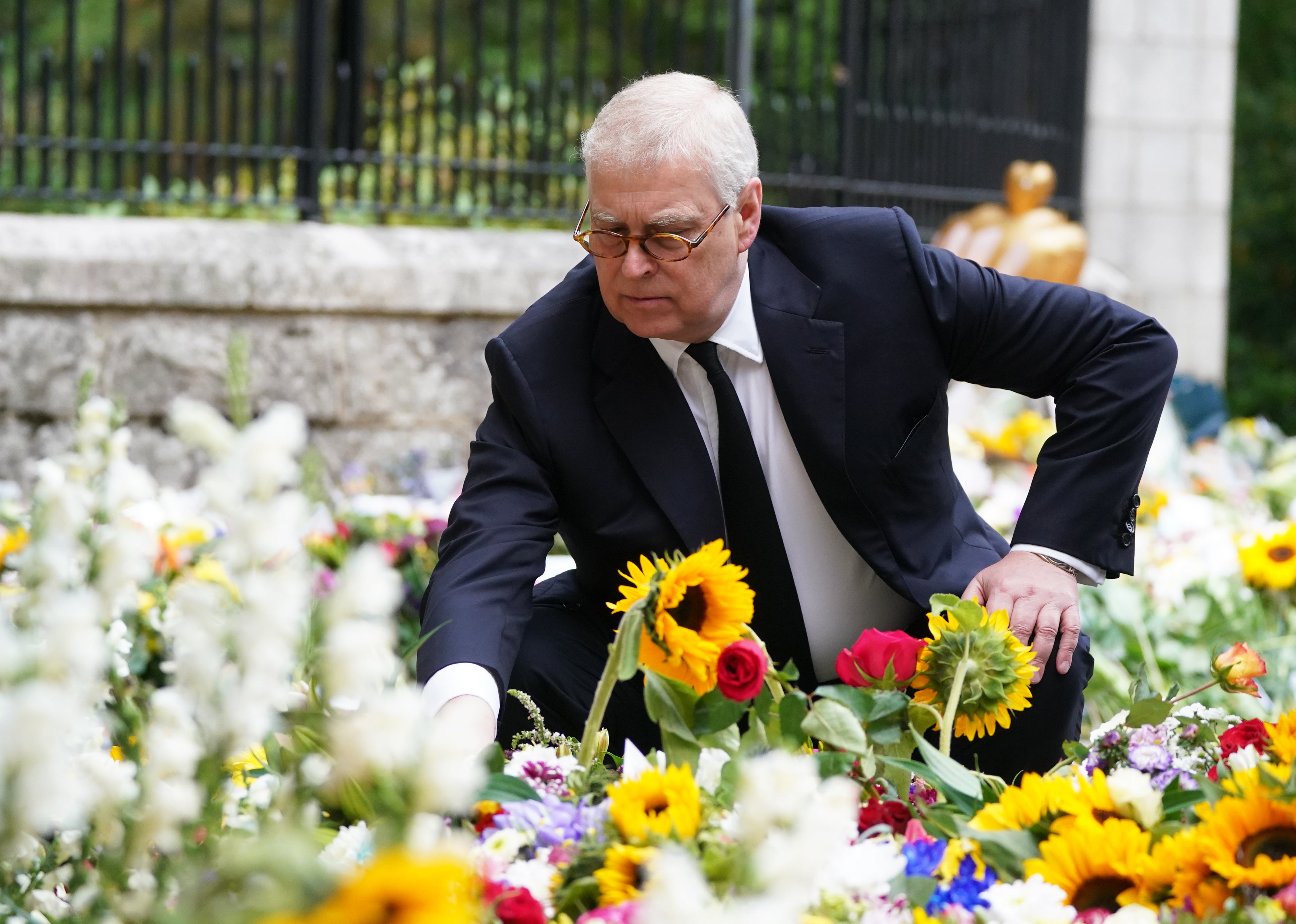 The Duke of York views the messages and floral tributes left by members of the public at Balmoral