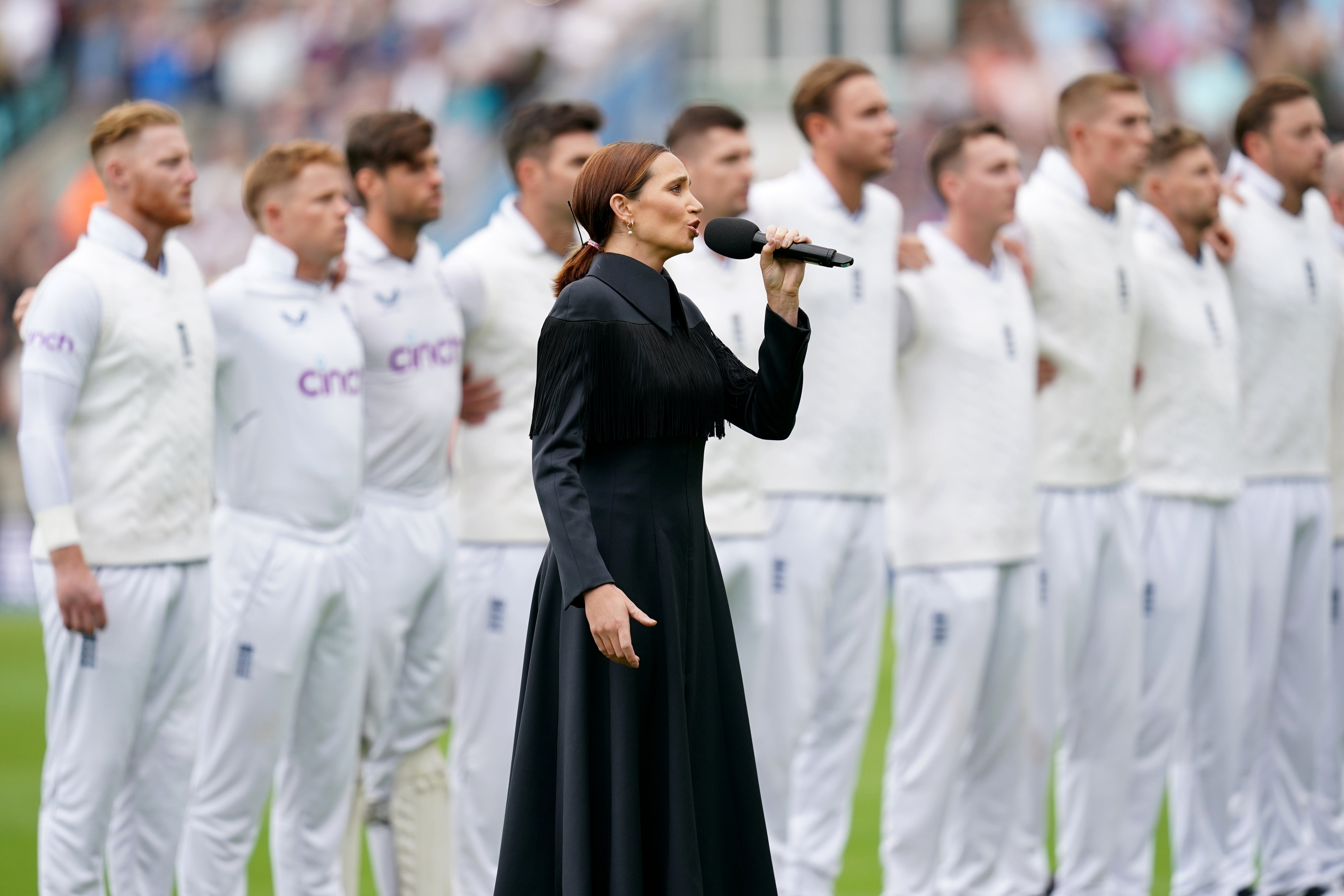 Laura Wright sings the national anthem and is joined by the England team (John Walton/PA)