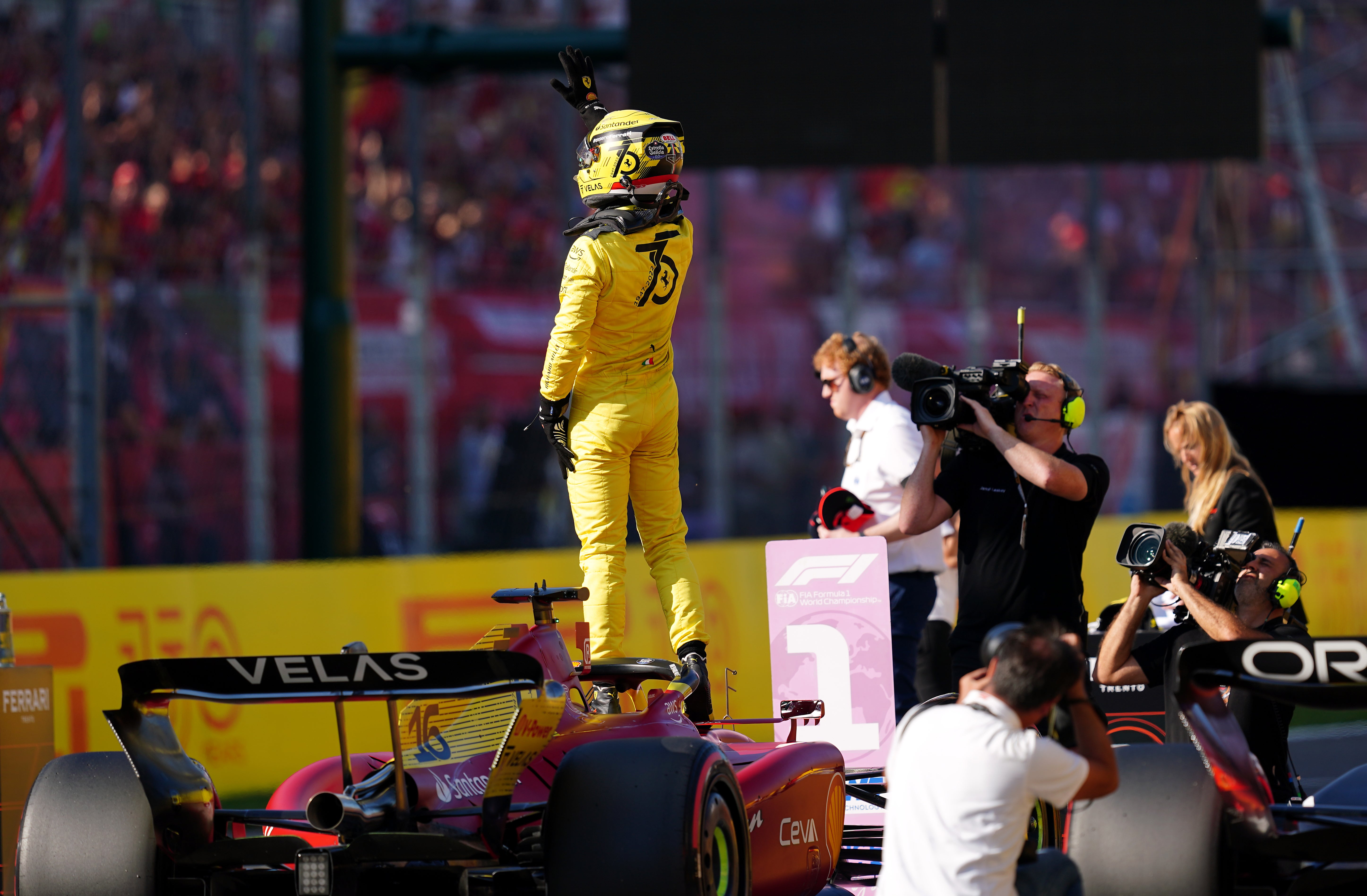 Charles Leclerc celebrates after claiming pole position