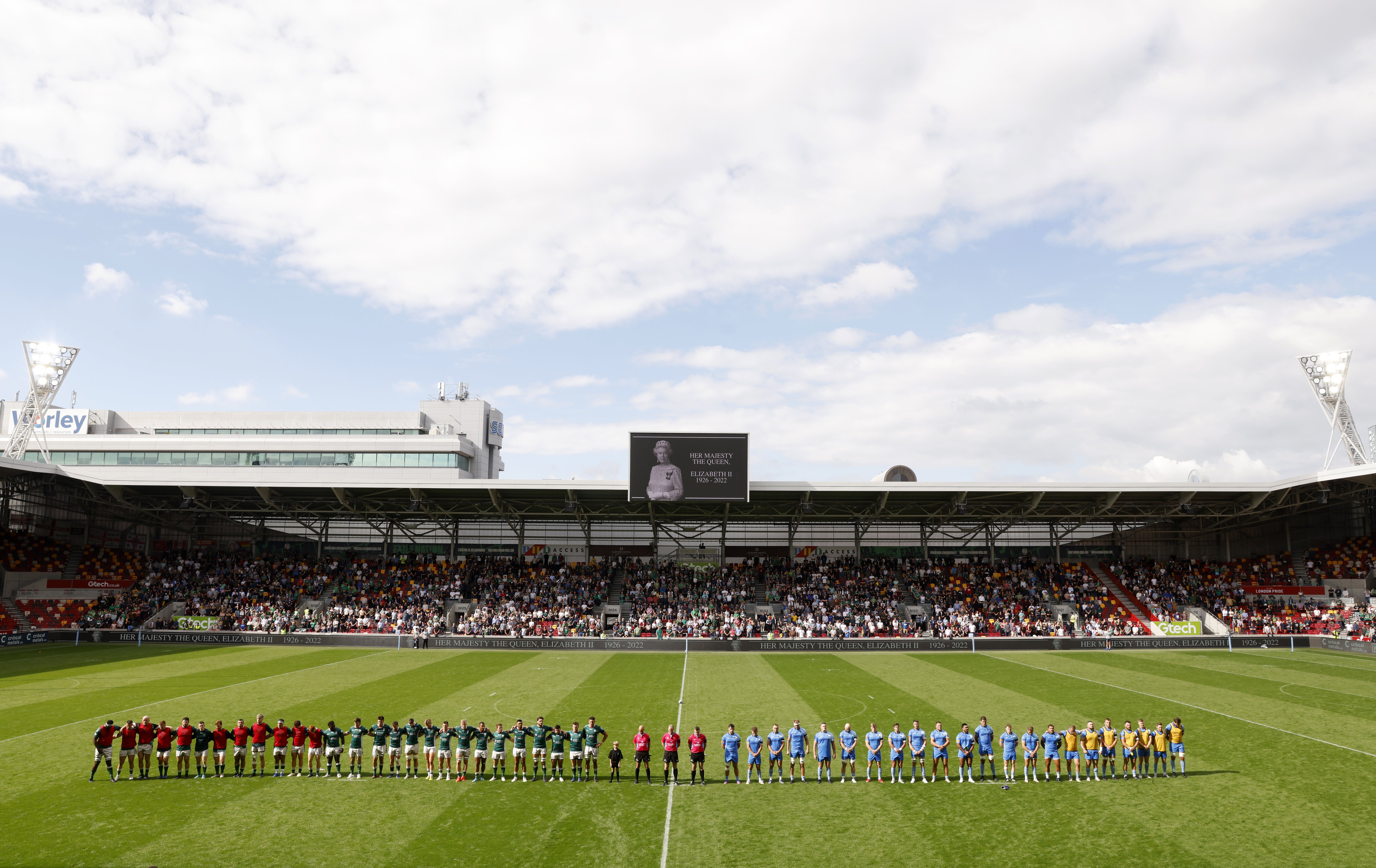 Players and officials observe a minute’s silence in memory of the Queen ahead of kick-off (Steven Paston/PA).