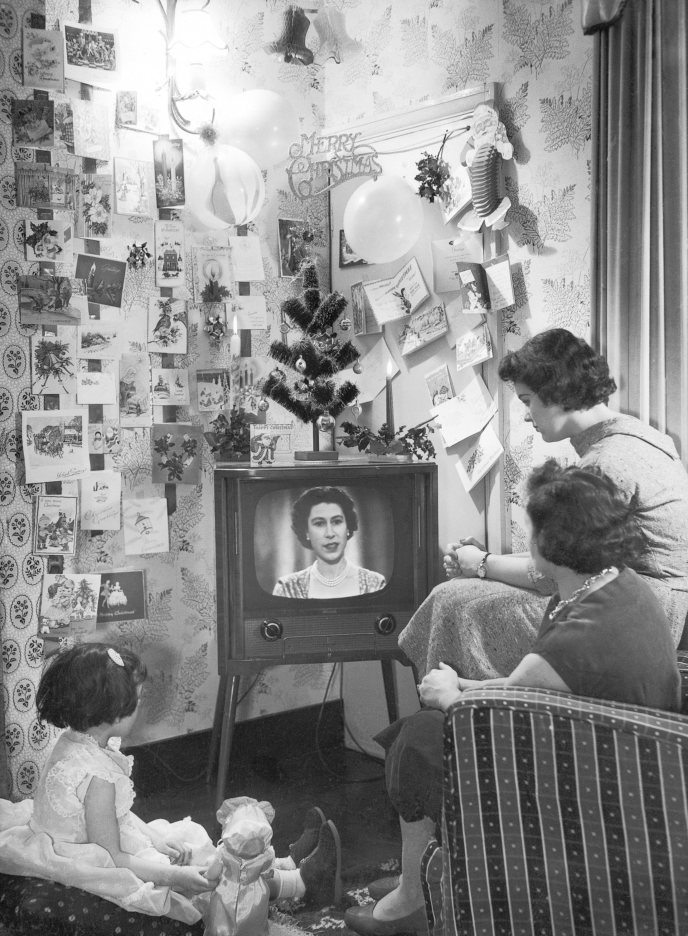 A family watch as Britain's Queen Elizabeth II makes her first televised Christmas broadcast on 25 December, 1957
