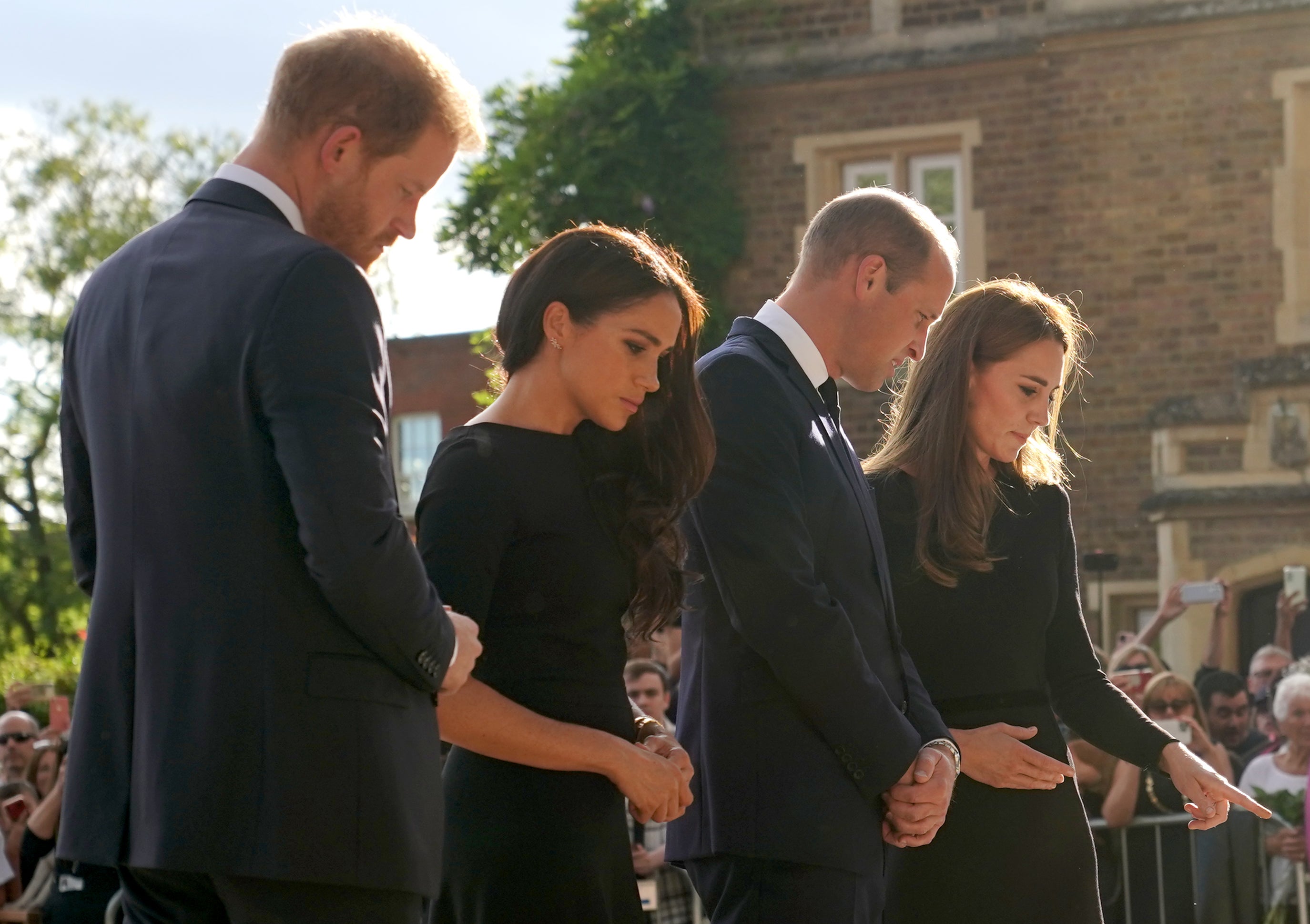 The Duke and Duchess of Sussex and the Prince and Princess of Wales view flowers left by members of the public at Windsor Castle (Kirsty O’Connor/PA)