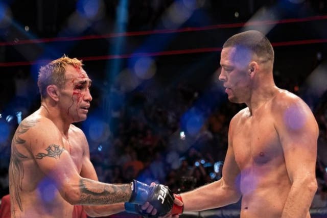 <p>Nate Diaz (right) is congratulated by beaten opponent Tony Ferguson</p>