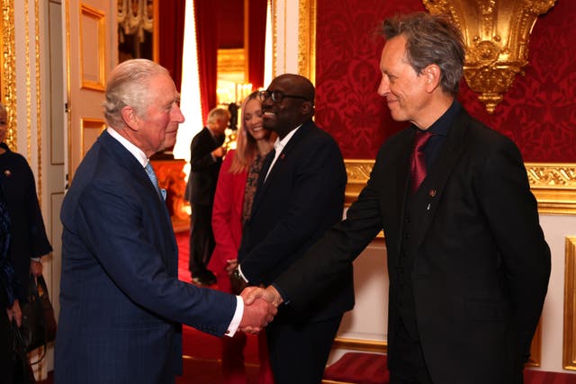 The Prince of Wales, now King Charles III, shakes hands with Richard E Grant (Tim P Whitby/PA)