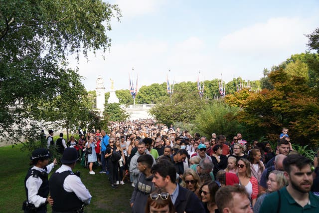 <p>Well-wishers queue to view floral tributes outside Buckingham Palace, London</p>