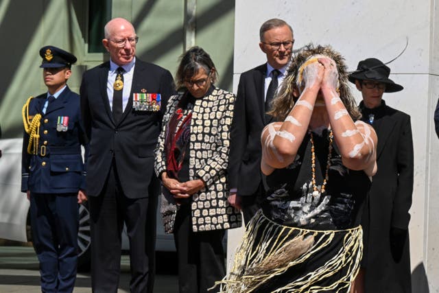 <p>An Indigenous dancer performs as governor general David Hurley, second left, and prime minister Anthony Albanese watch the proclamation of King Charles III in Canberra</p>