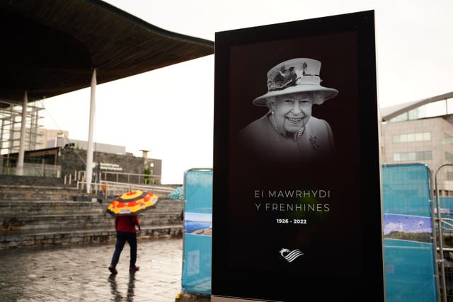 A tribute to Queen Elizabeth II is displayed on a screen outside the Senedd Building in Cardiff (PA)