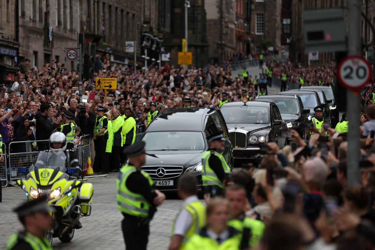 Applause from packed crowds as Queen’s cortege made its way down the Royal Mile