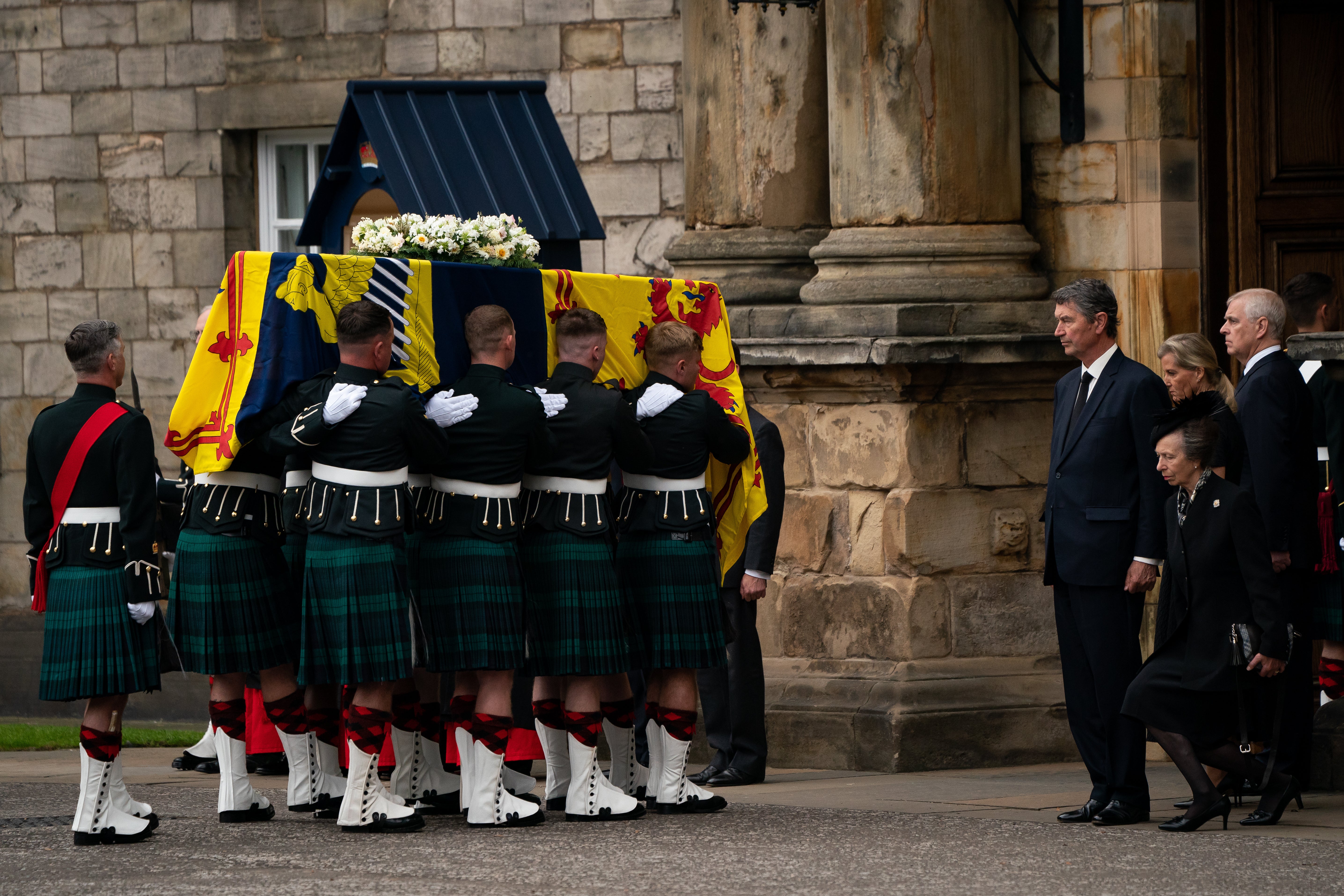 The Princess Royal curtseys to the Queen’s coffin as it arrives at the Palace of Holyroodhouse (Aaron Chown/PA)