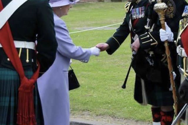 <p>Pipe Major Scott Methven from the Royal Regiment of Scotland shaking hands with Queen Elizabeth II (Scott Methven/PA)</p>