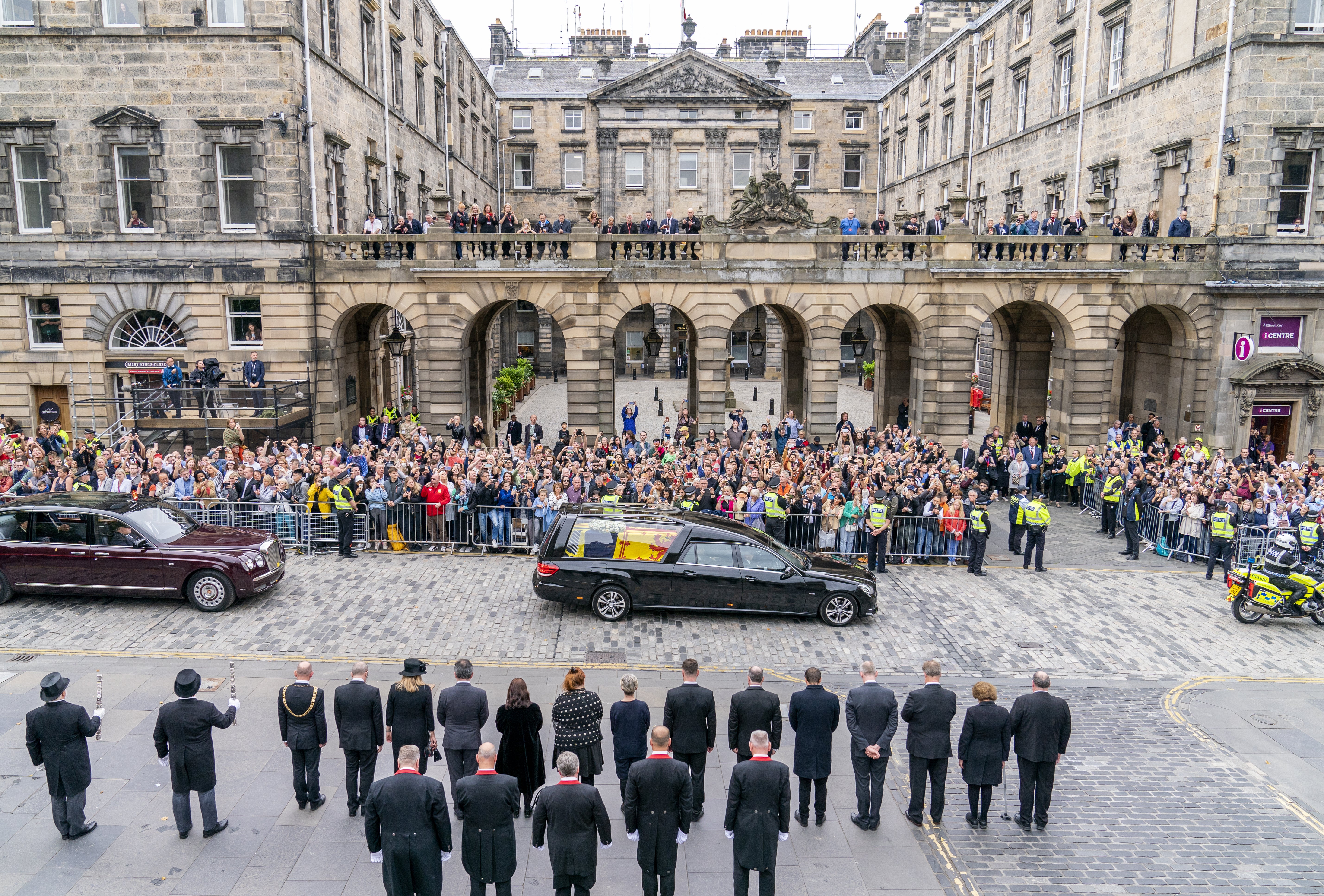 The hearse carrying the Queen’s coffin passes the City Chambers on the Royal Mile, Edinburgh, on the journey from Balmoral to the Palace of Holyroodhouse (Jane Barlow/PA)