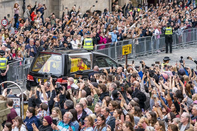 Large crowds watched the coffin arrive on Sunday (Jane Barlow/PA)