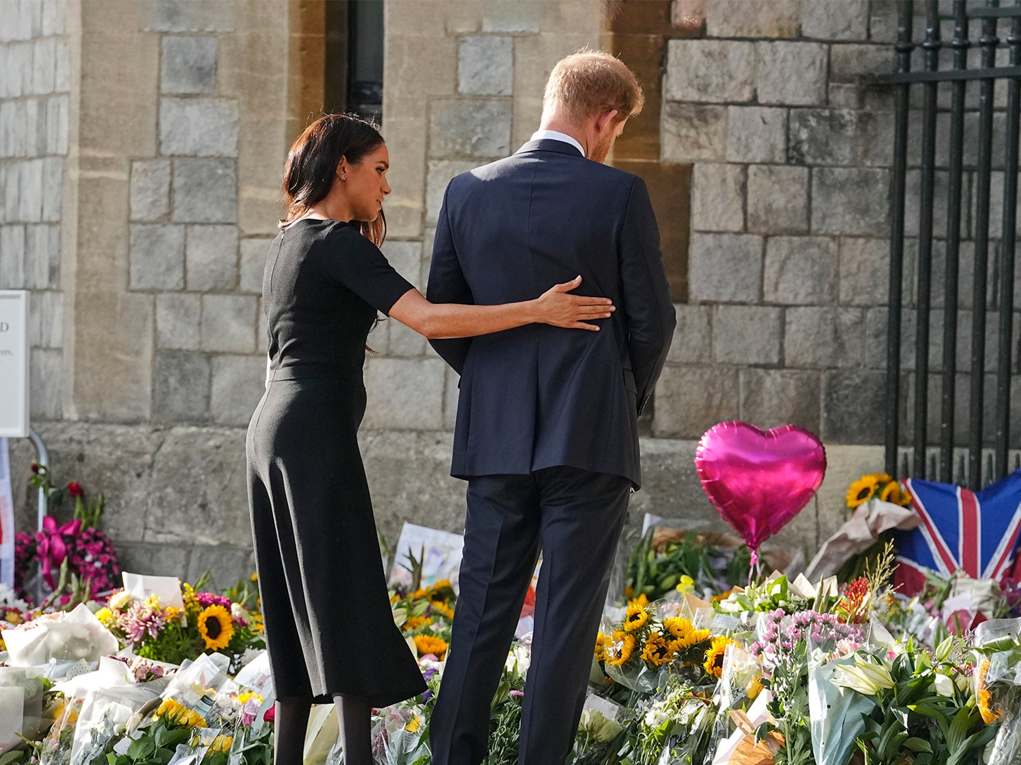 Meghan comforted her husband as they read messages together